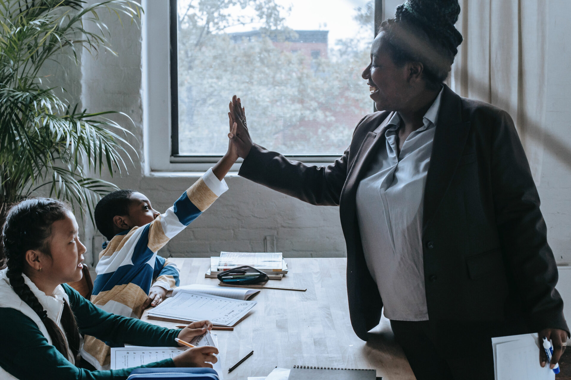 Teacher high five with Early Years student